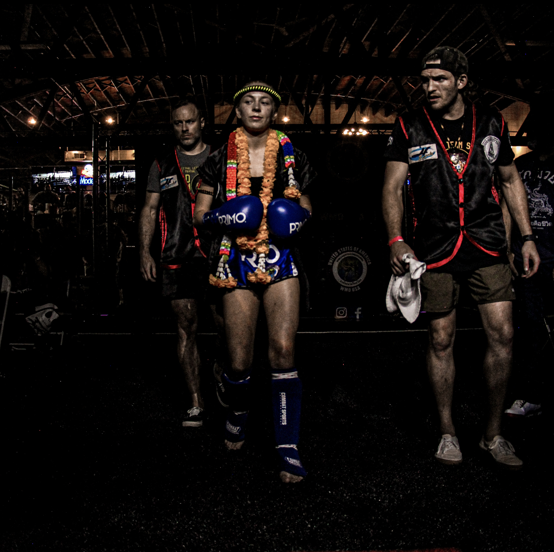 Female WMO USA fighter walking out with traditional flower garland and mongkol