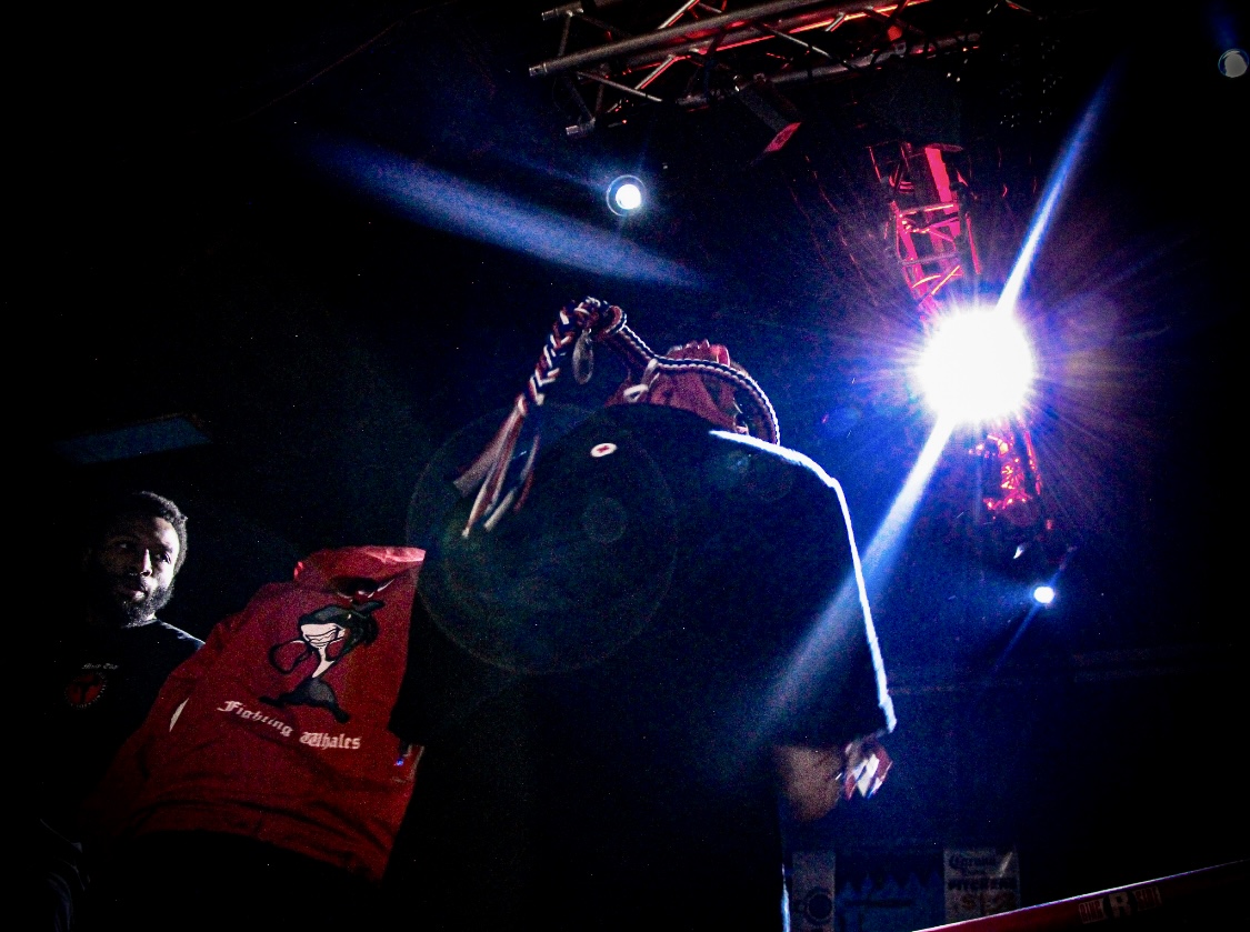 WMO USA fighter wearing the mongkol under stage lights — Fight Night